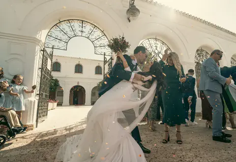 The couple leaving through their guests in the courtyard of an Andalusian hacienda